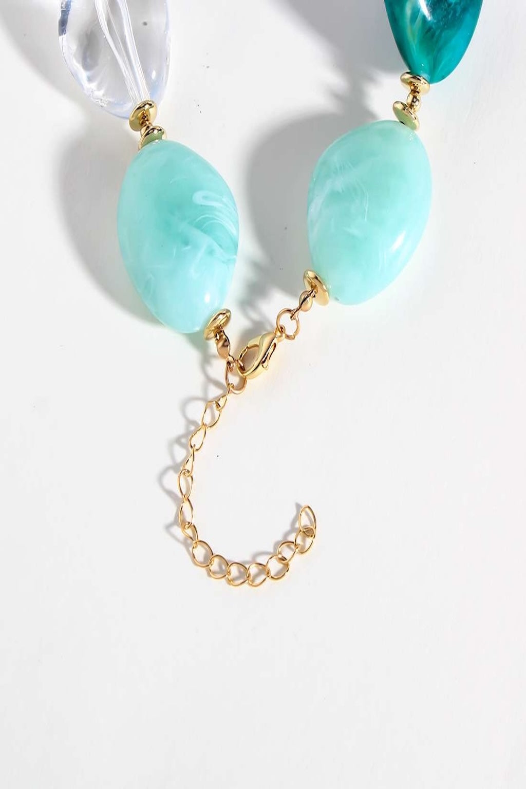 Dramatic emerald-green chunky necklace with vintage-inspired design and bohemian flair.